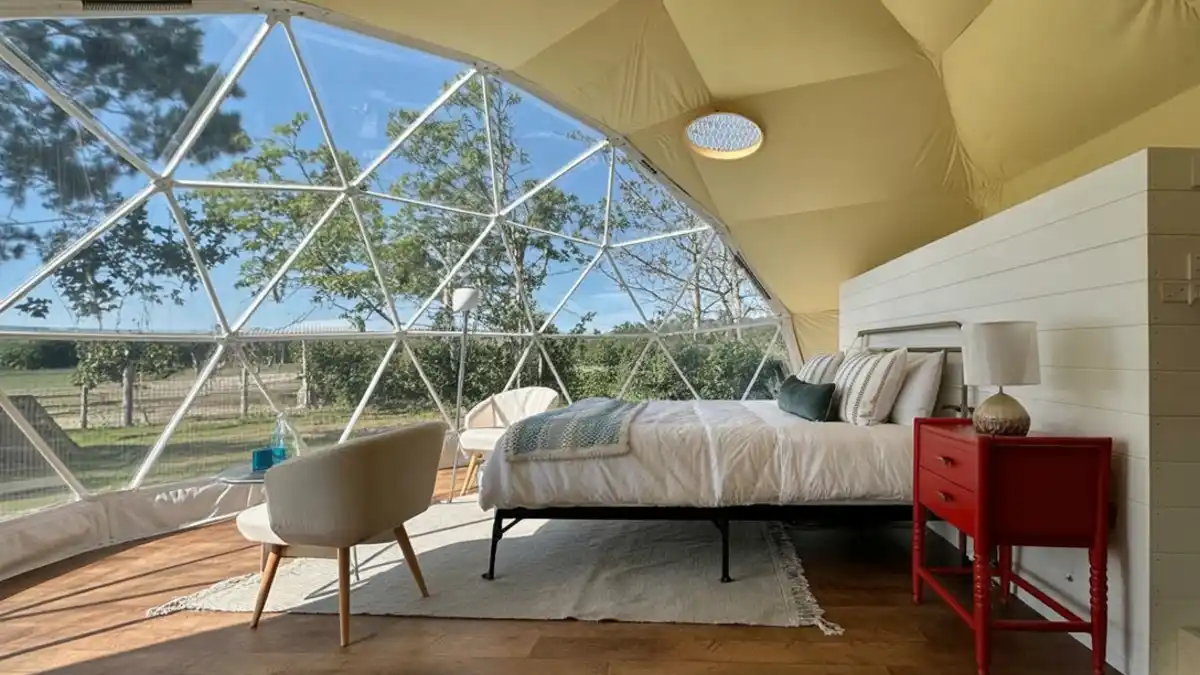 Sun-Drenched Canvas and Crimson Retreat - A Geodesic Dome Bedroom with a View
